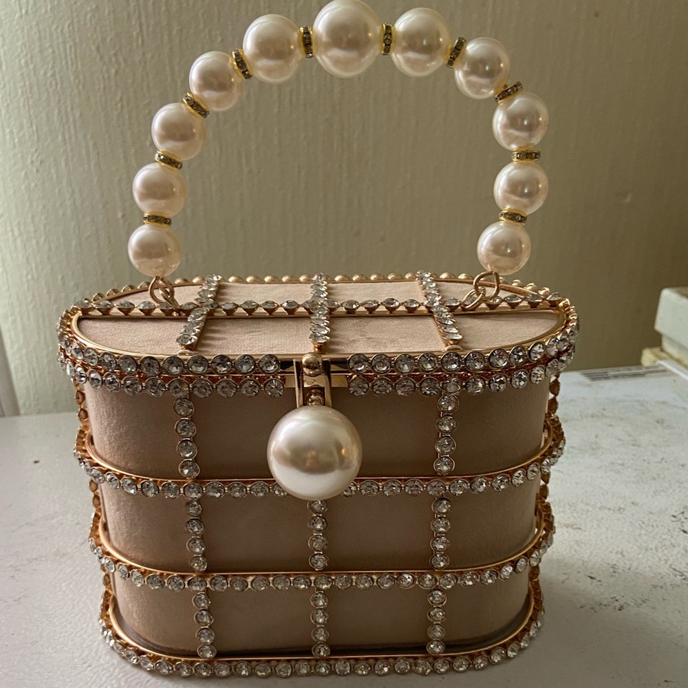 Nude pearl clutch bag